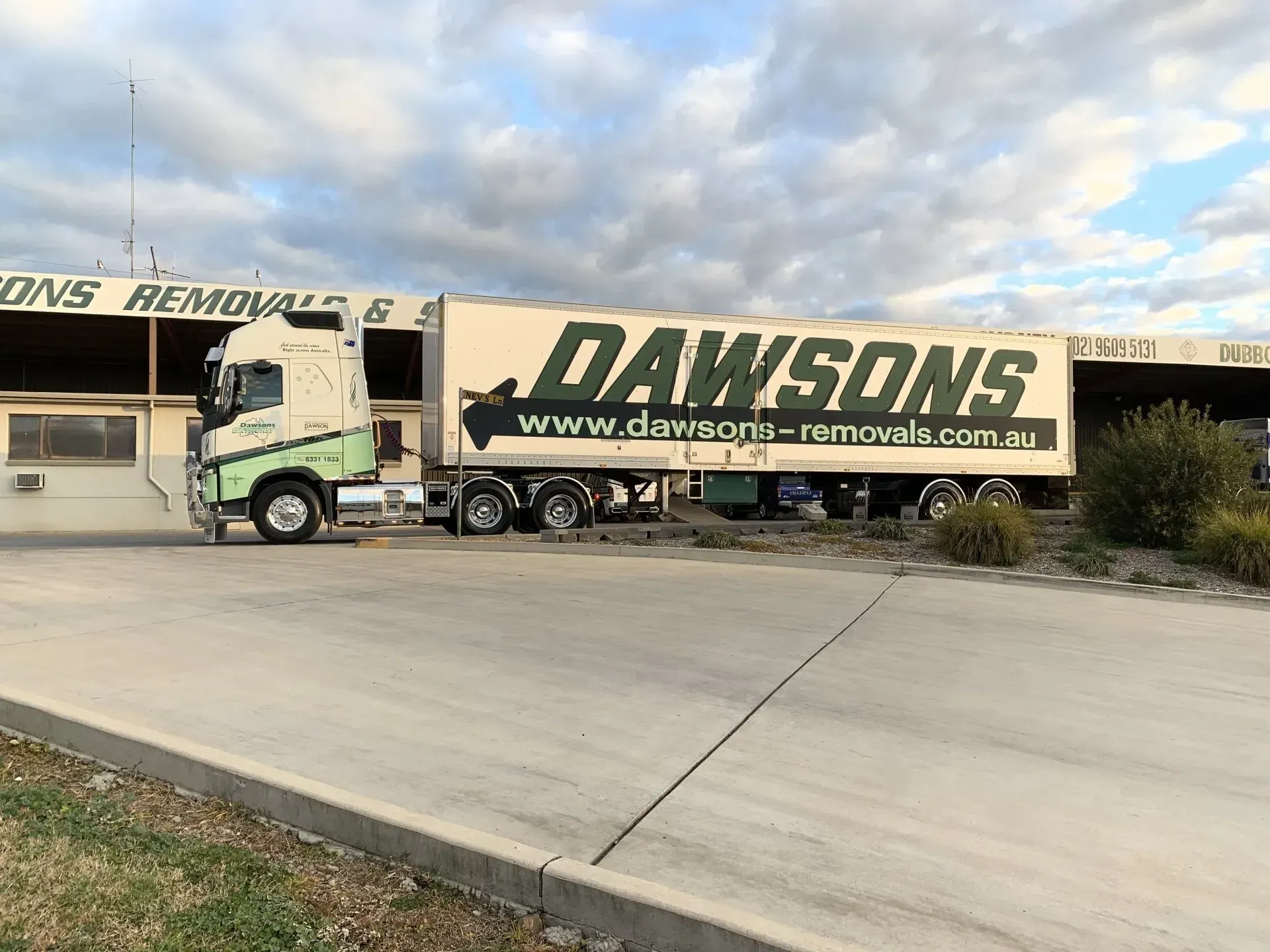 Dawsons Removals Truck Parked by A Warehouse Under a Cloudy Sky — Dawson's Removals In Kelso, NSW
