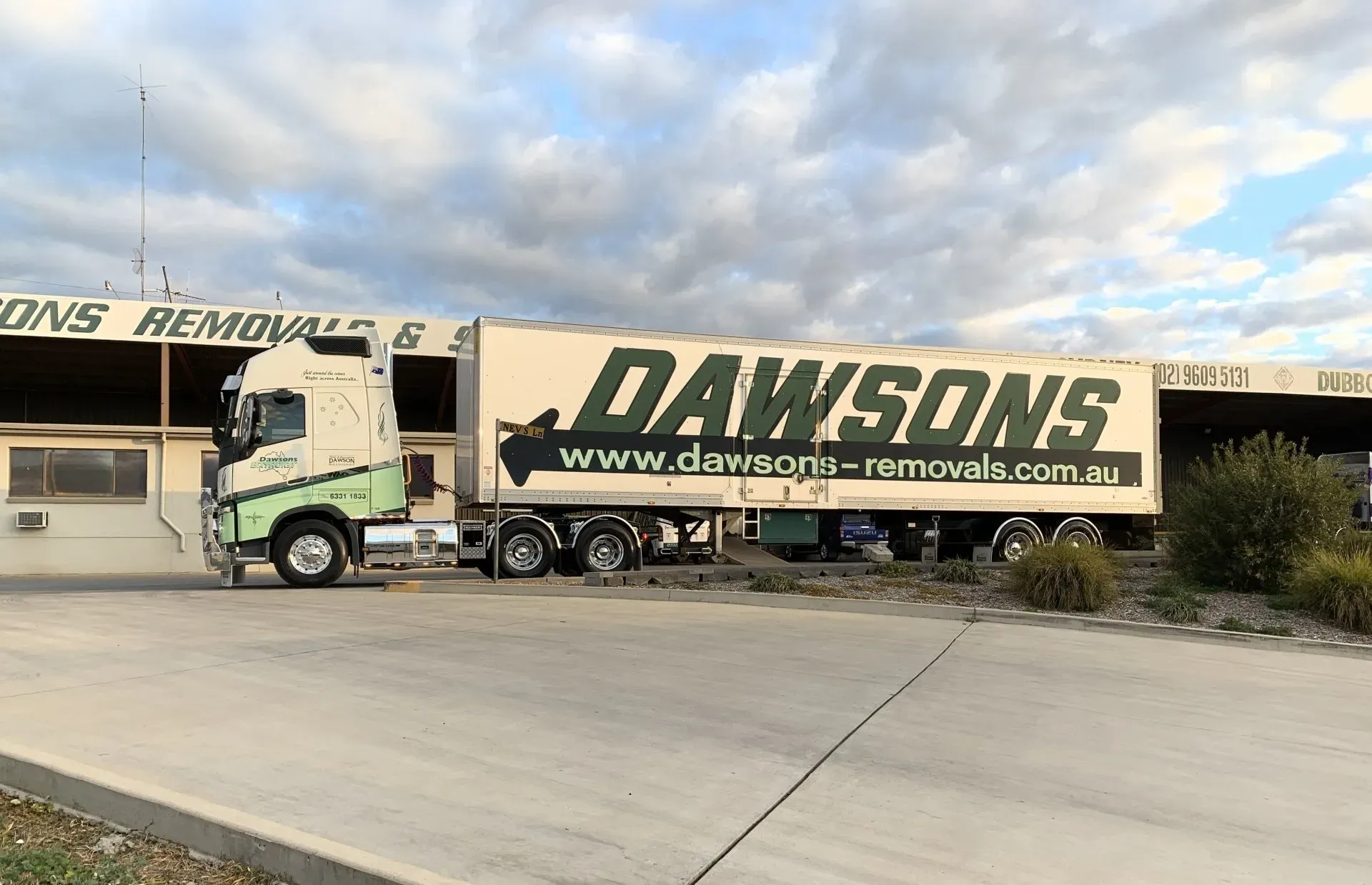 Dawsons Removals Truck Parked Outside a Warehouse Under a Cloudy Sky — Dawson's Removals In Kelso, NSW