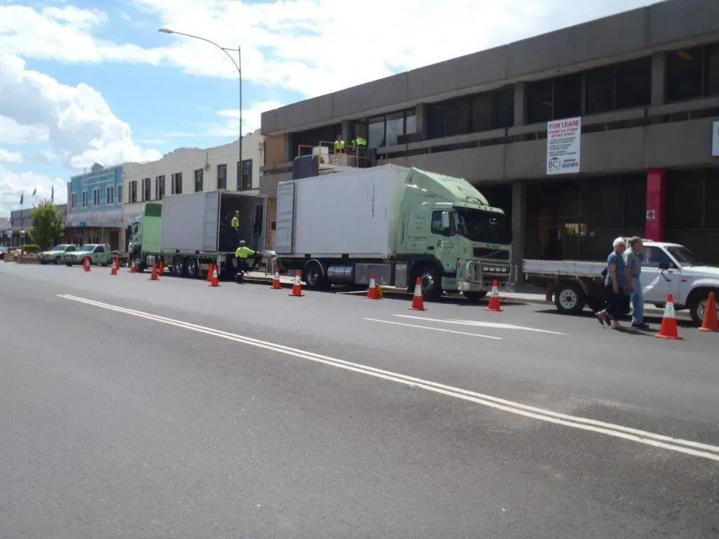 Two large trucks are packed on the side of the road while moving office belongings— Dawson's Removals In Wetherill Park, NSW