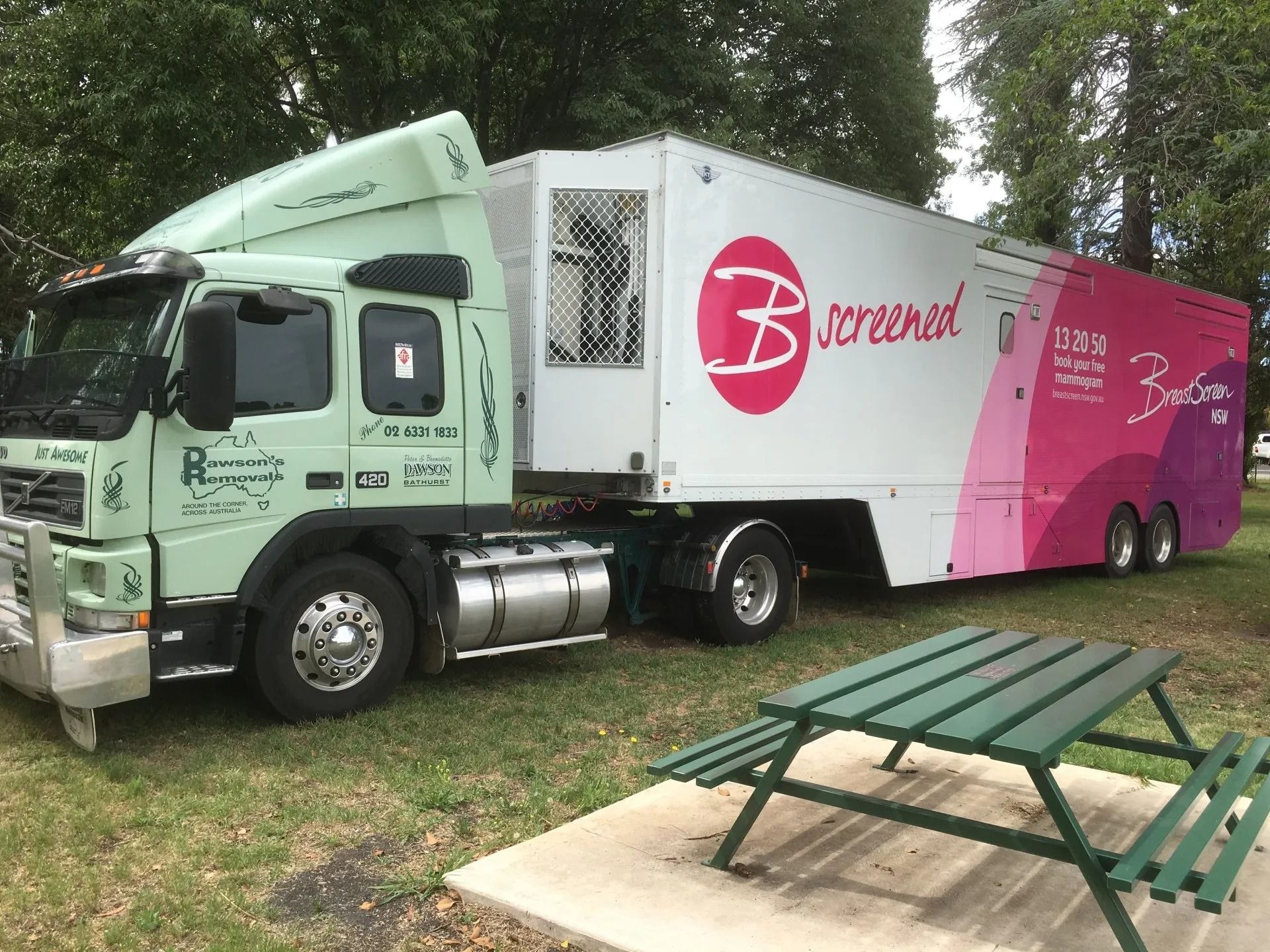 A Green Semi-truck With a Trailer Labeled — Dawson's Removals In Kelso, NSW