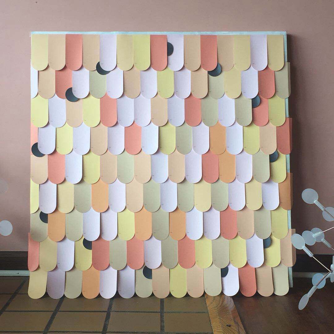 A piece of paper that looks like a roof is sitting on a tiled floor