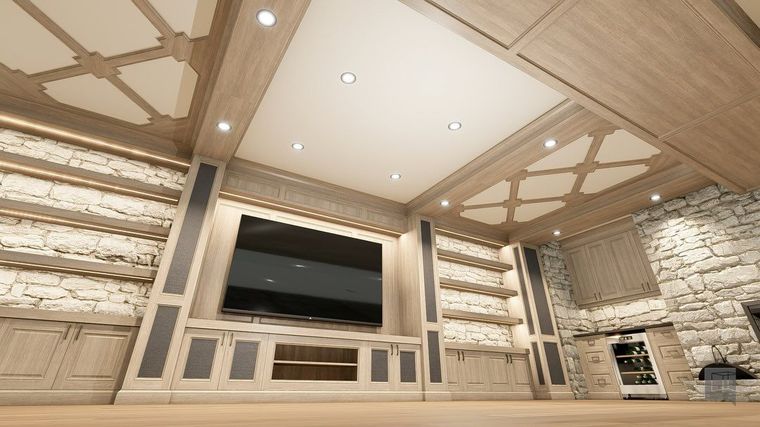 A modern living room with a large wall-mounted TV, built-in shelving, stone accents, and detailed wooden tray ceilings.
