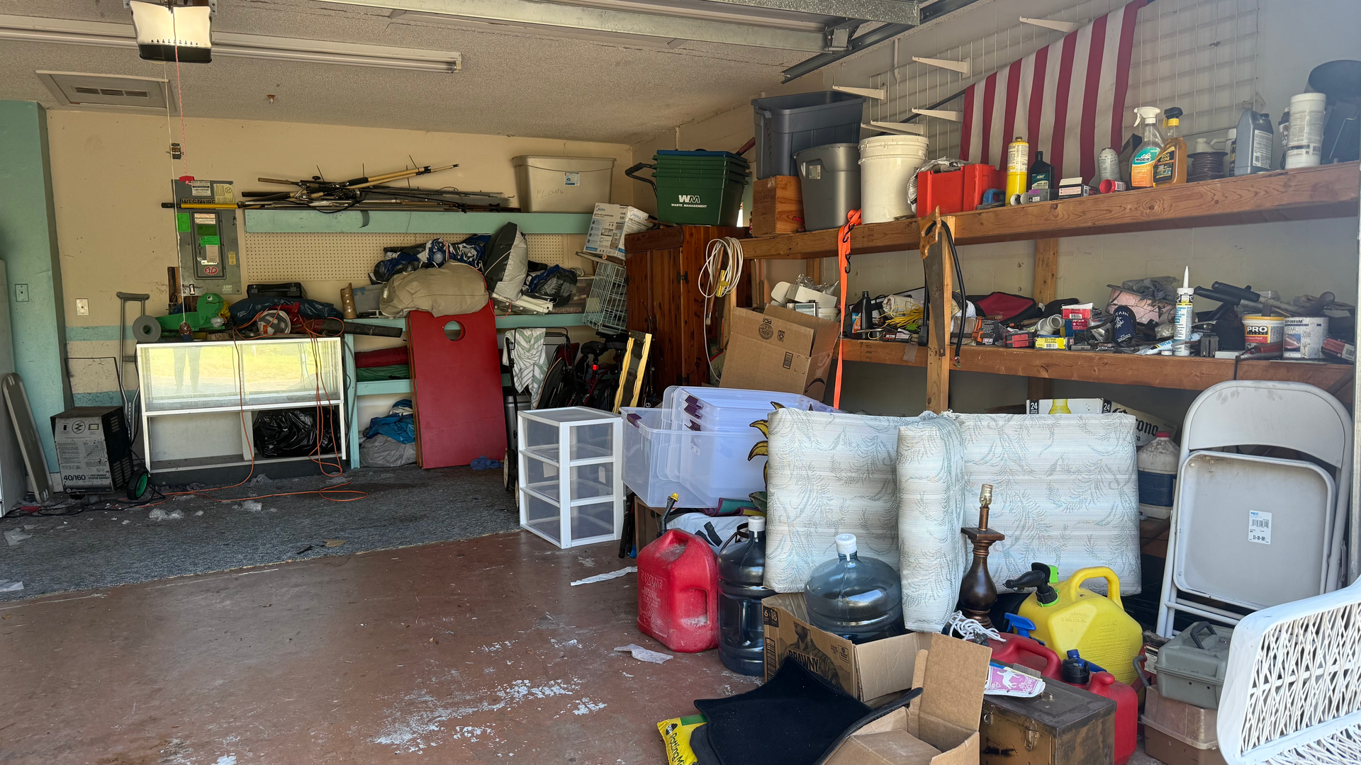 A garage filled with lots of junk and boxes.