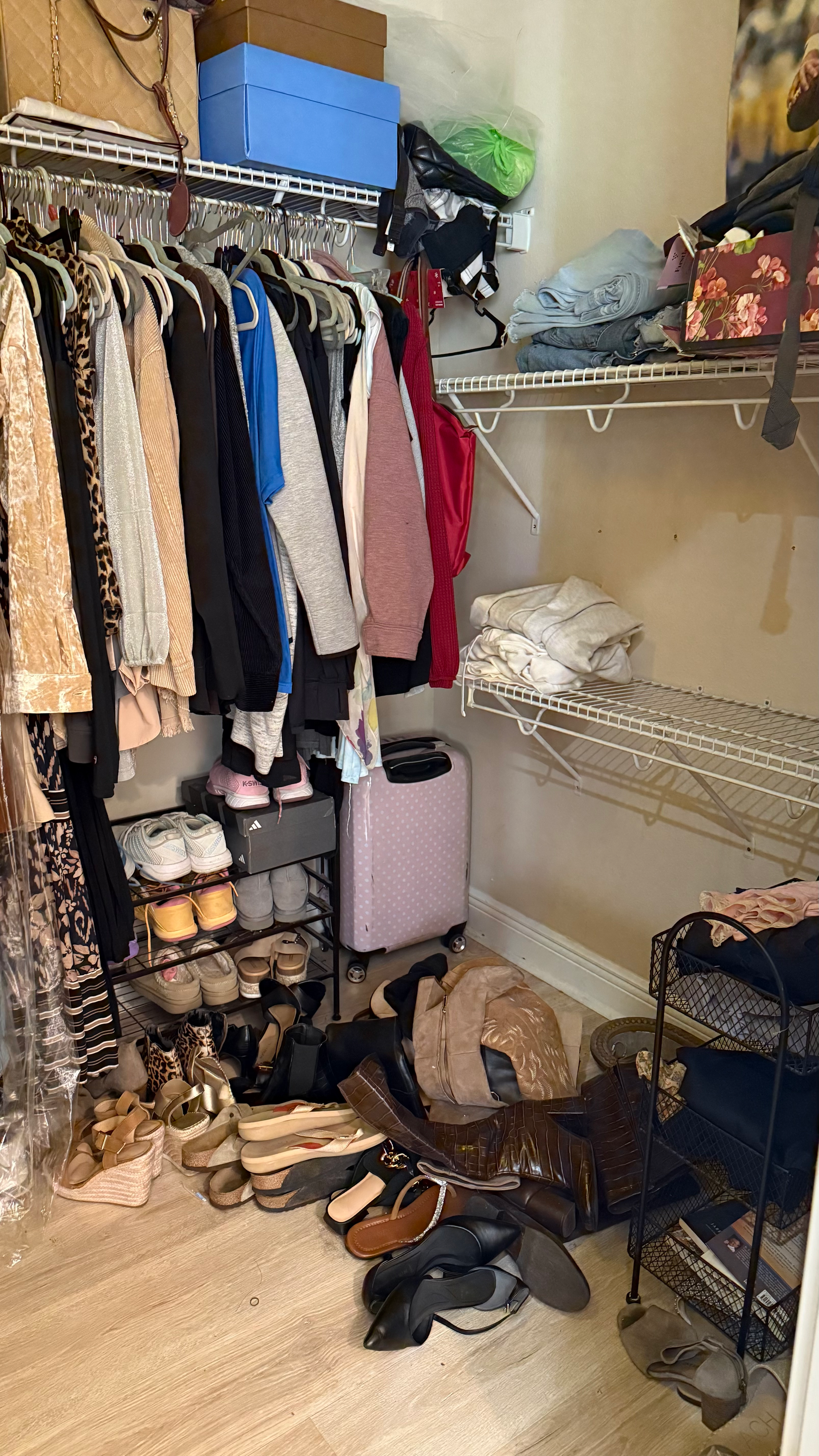 A closet filled with lots of clothes and shoes.