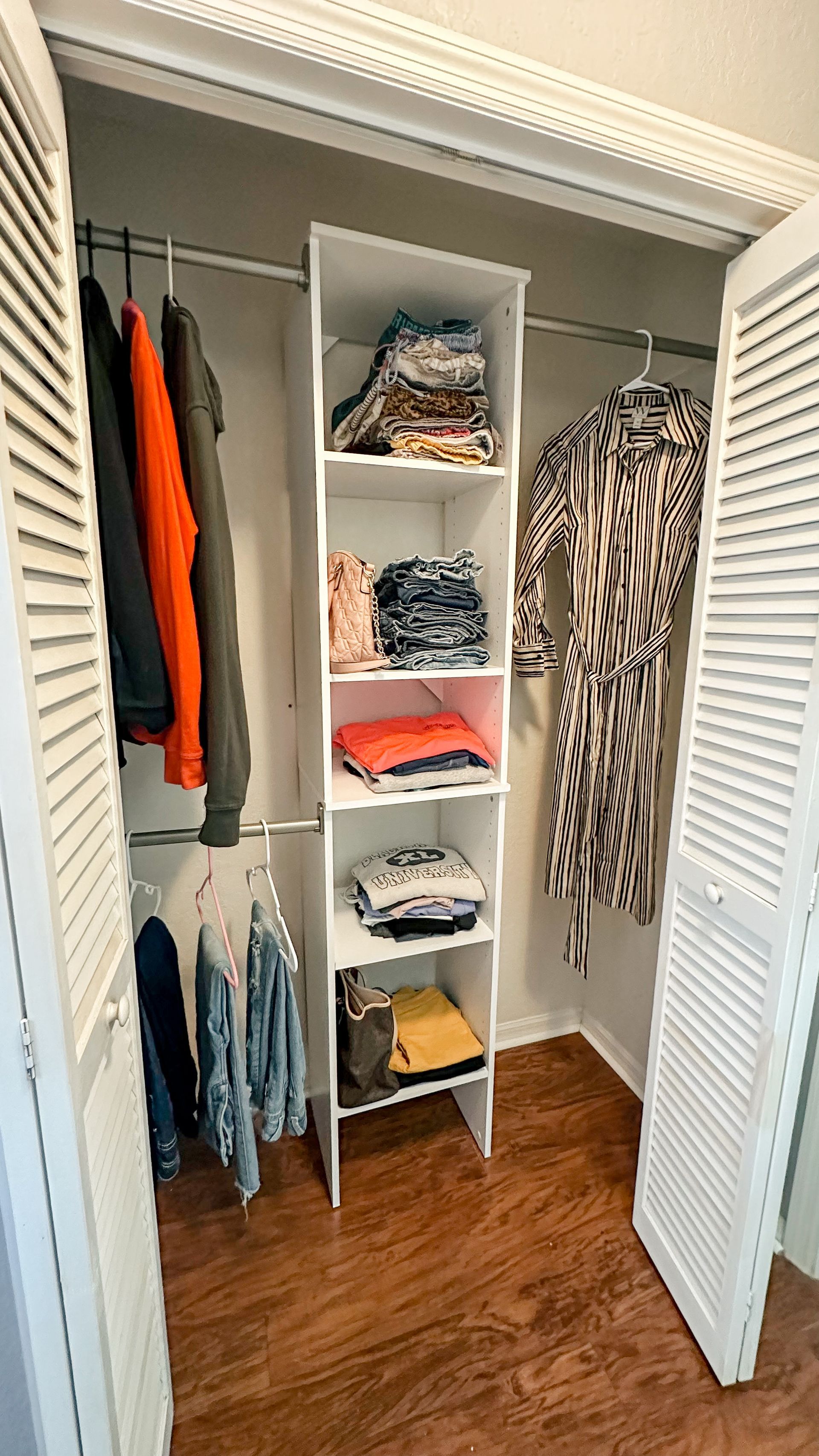A closet filled with clothes and a dress.