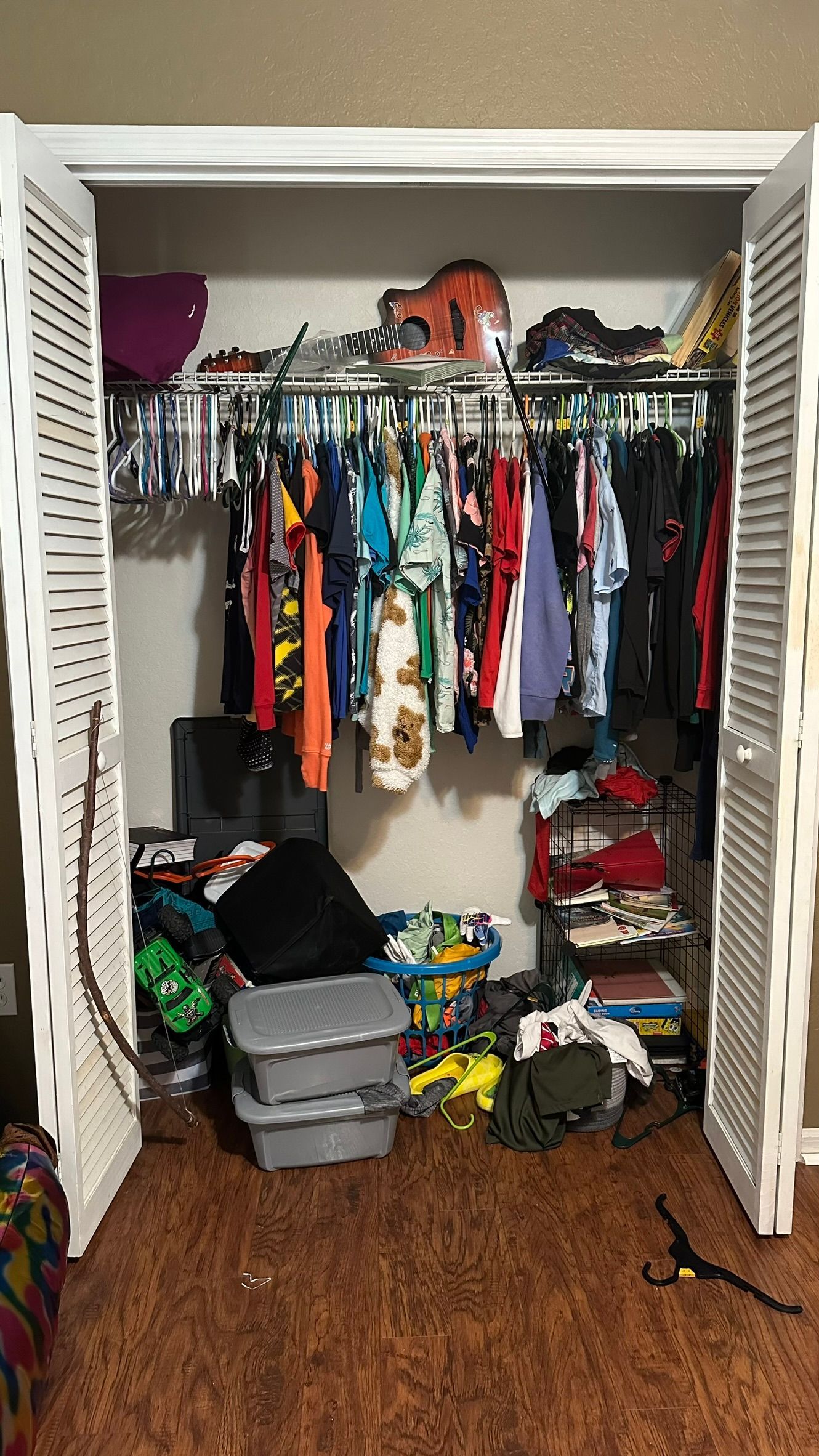 A closet filled with lots of clothes and toys.
