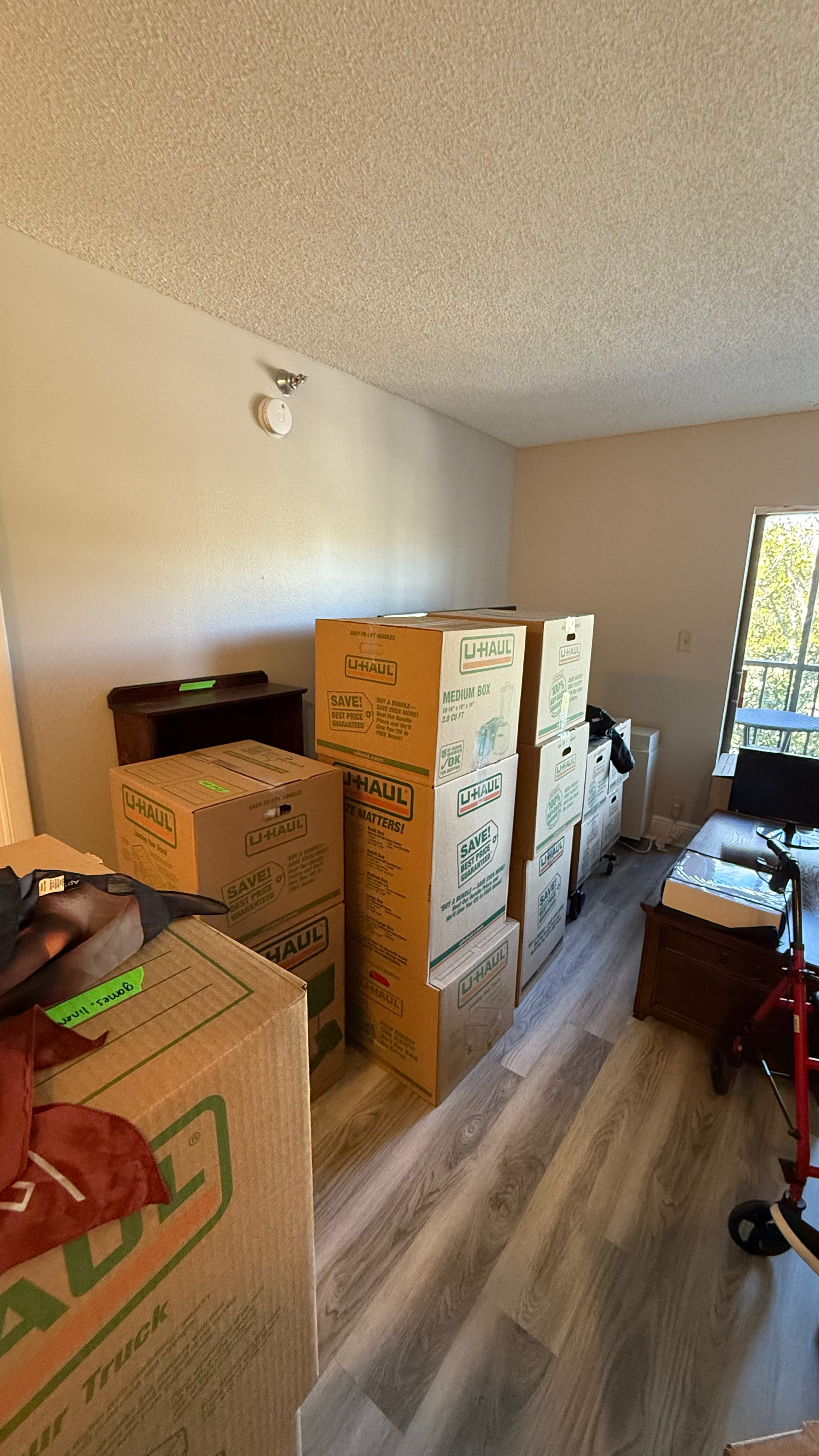 A room filled with lots of cardboard boxes and a desk.