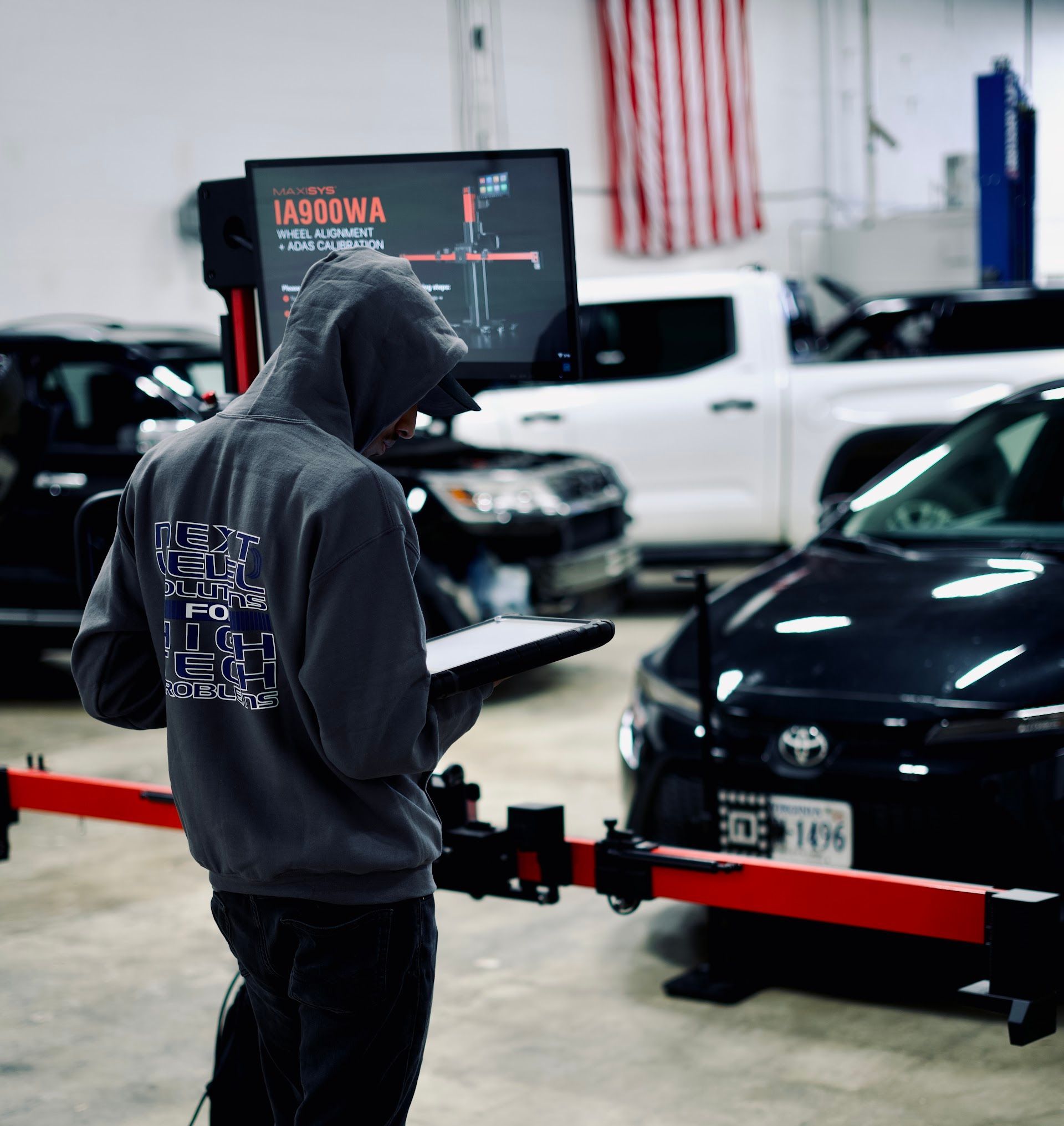 Automotive Technician Performing Wheel Alignment Check | Level 5 Fairfax