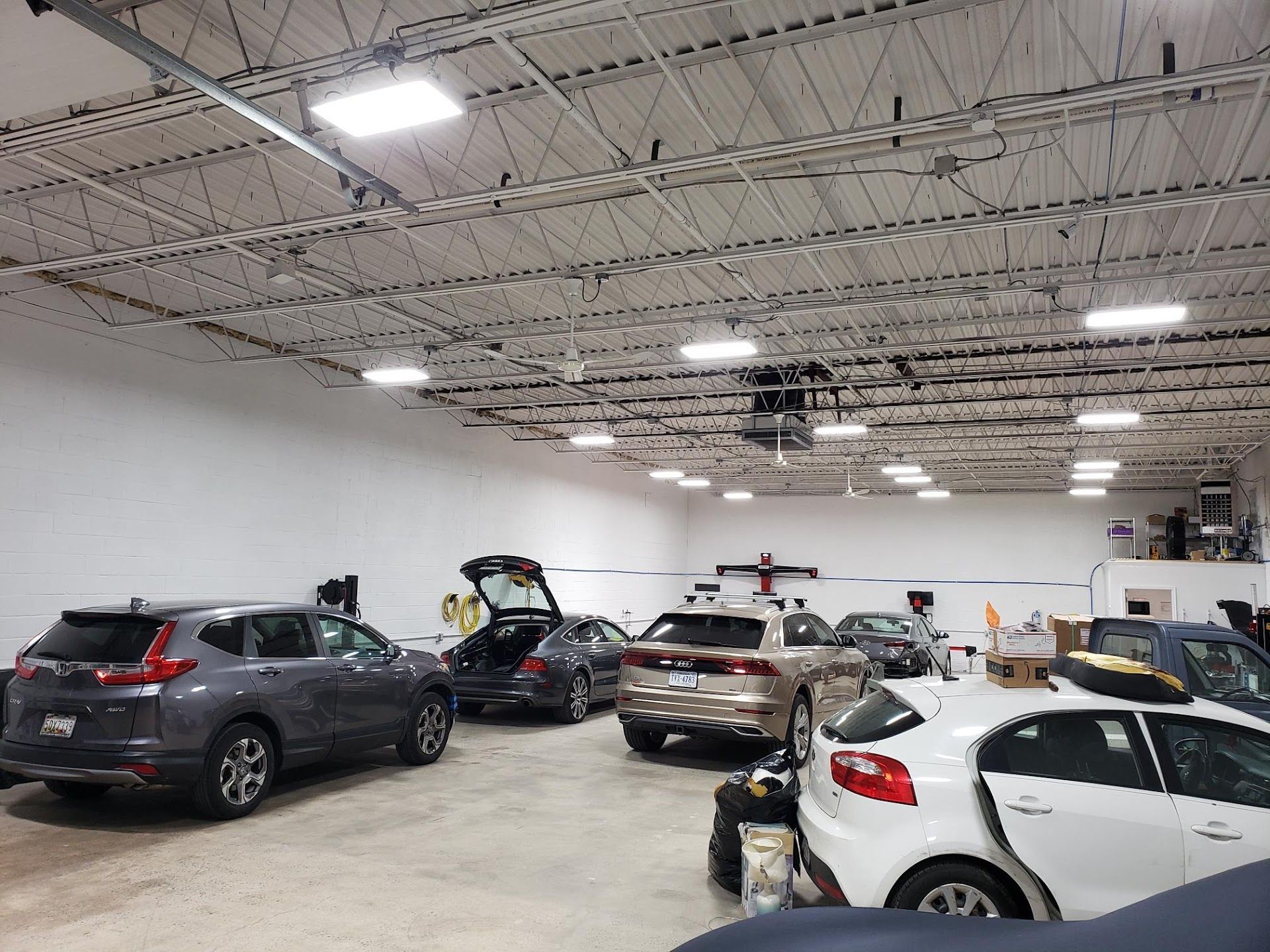 Spacious Indoor Auto Service Bay With Multiple Vehicles | Level 5 Fairfax