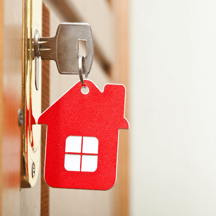 Red house keyring in a door - Adair Mortgage Advisers Christchurch