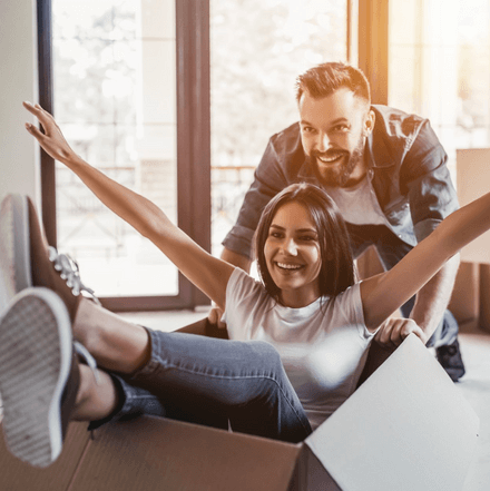 Woman in a box being pushed by a man - First Home Buyer Mortgage Specialists  - Adair Mortgage Advisers Christchurch