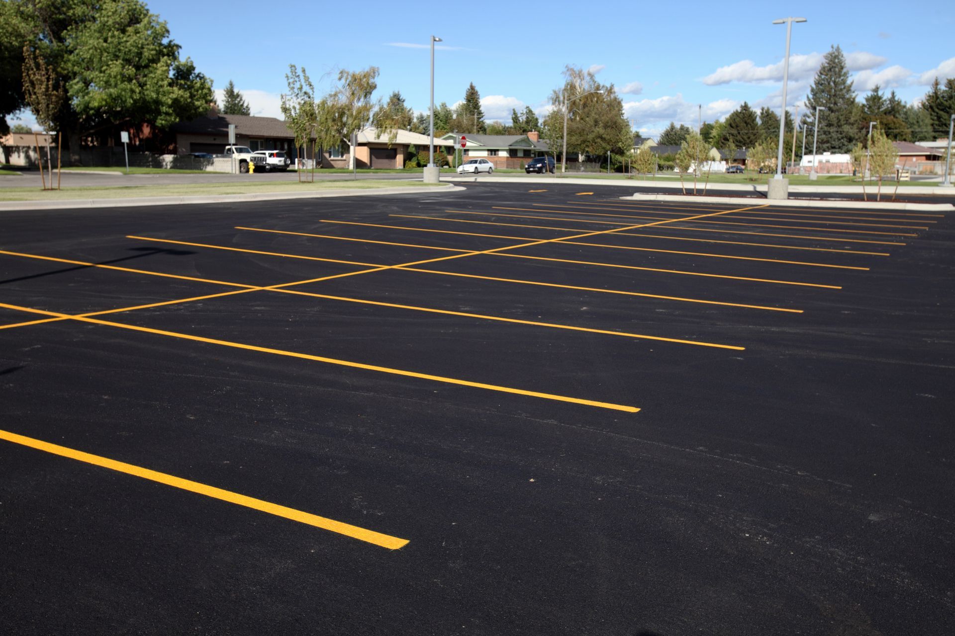 An empty parking lot with yellow lines on it