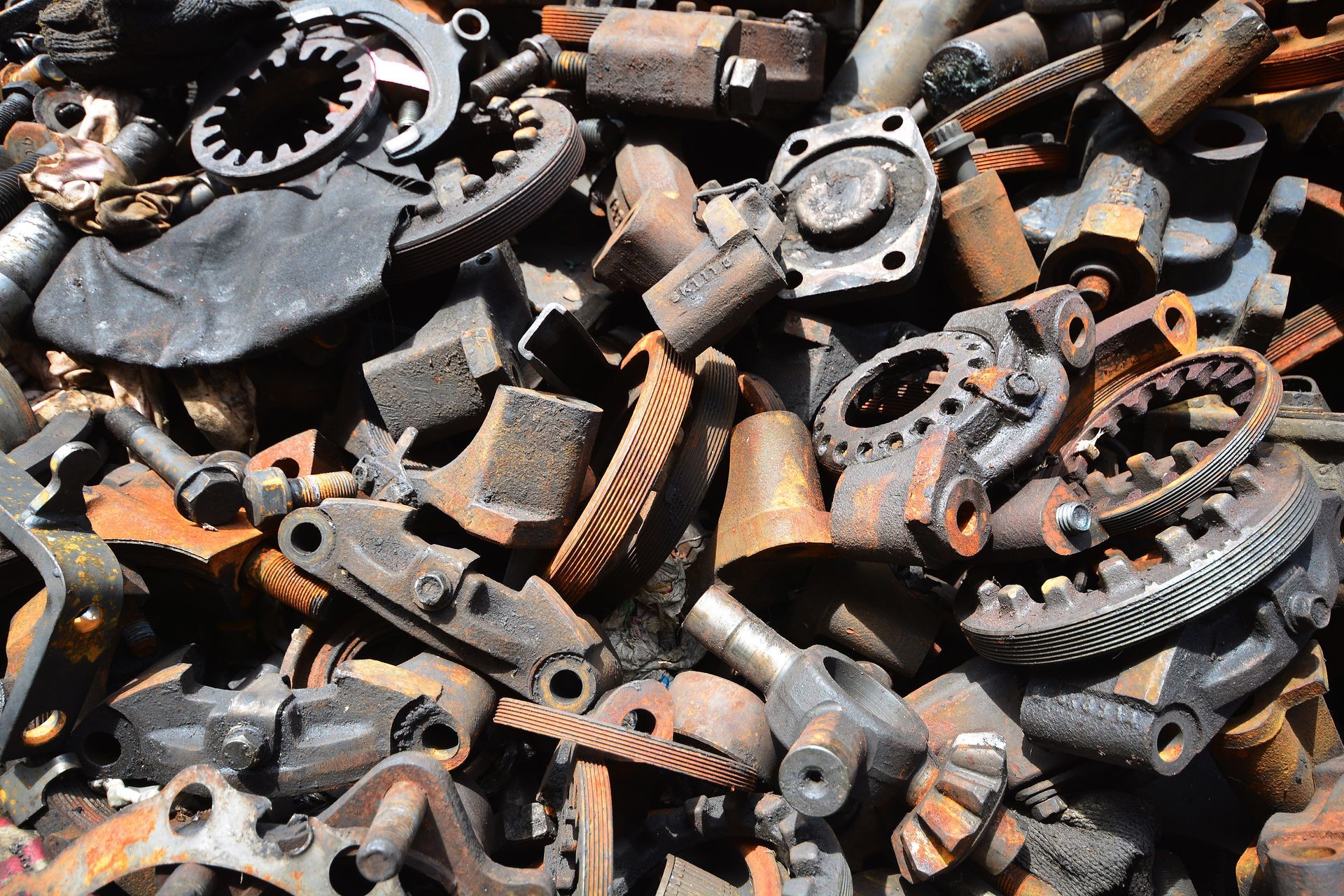 A Pile of old motor parts and scrap metal for recycling, from a scrap metal recycling company.