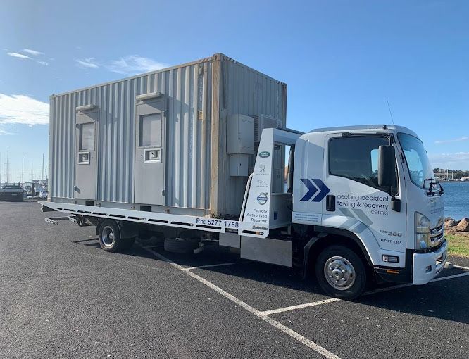 Flatbed Truck Carrying a Grey Shipping Container — Geelong Accident Towing & Recovery Centre In North Geelong, VIC