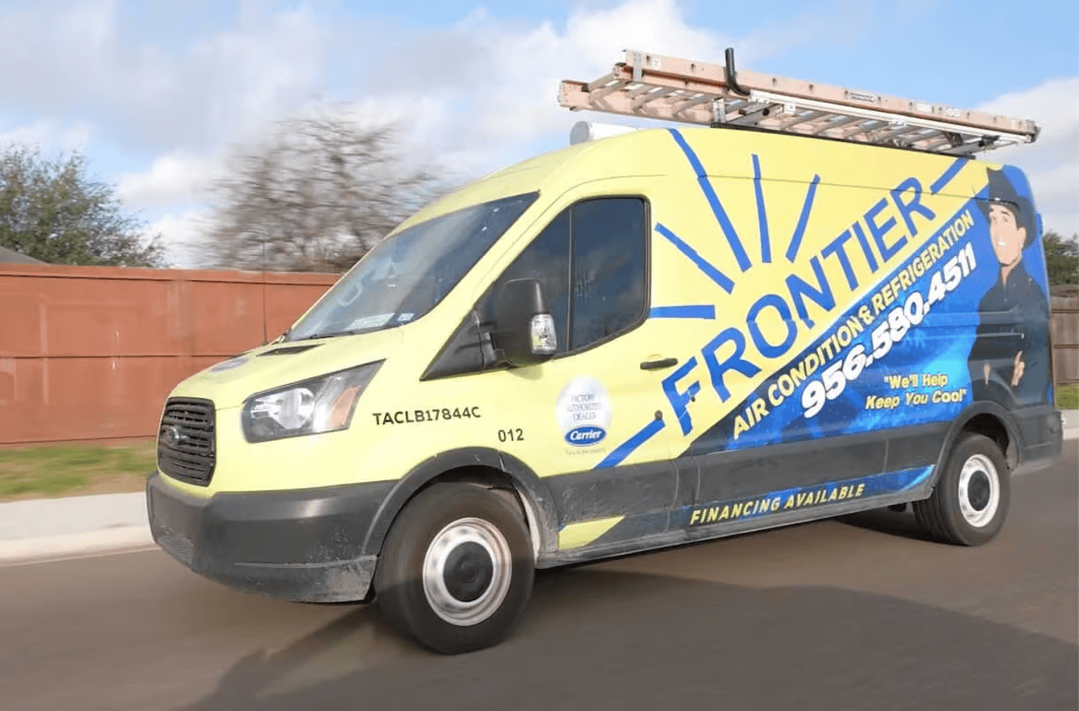 A yellow Frontier Air Conditioning & Refrigeration service van parked on a street with a ladder on its roof.
