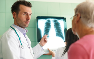 Doctor discussing chest X-ray with patient in clinic