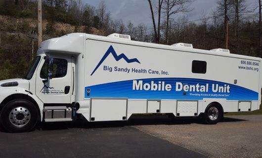 White mobile dental clinic truck parked outdoors, labeled “Big Sandy Health Care, Inc. Mobile Dental Unit”