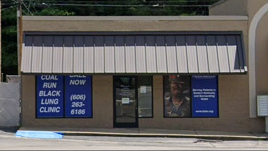 Storefront with blue signs for Clun Black Lung Clinic and NOW, under a beige awning.