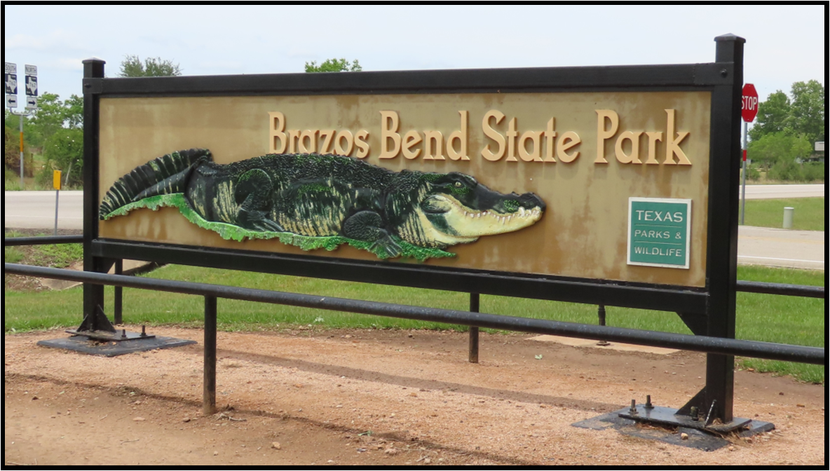 A sign for brazos bend state park with an alligator on it