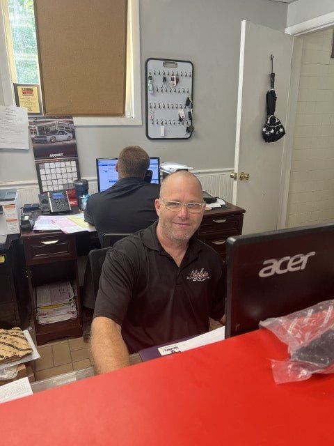 A man sitting in front of an computer