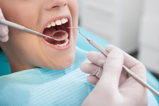 Restorative Dentistry — Dentist Checking Teeth in Pittsburgh, PA