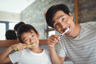Teeth Whitening — Father and Son Brushing Teeth in Pittsburgh, PA