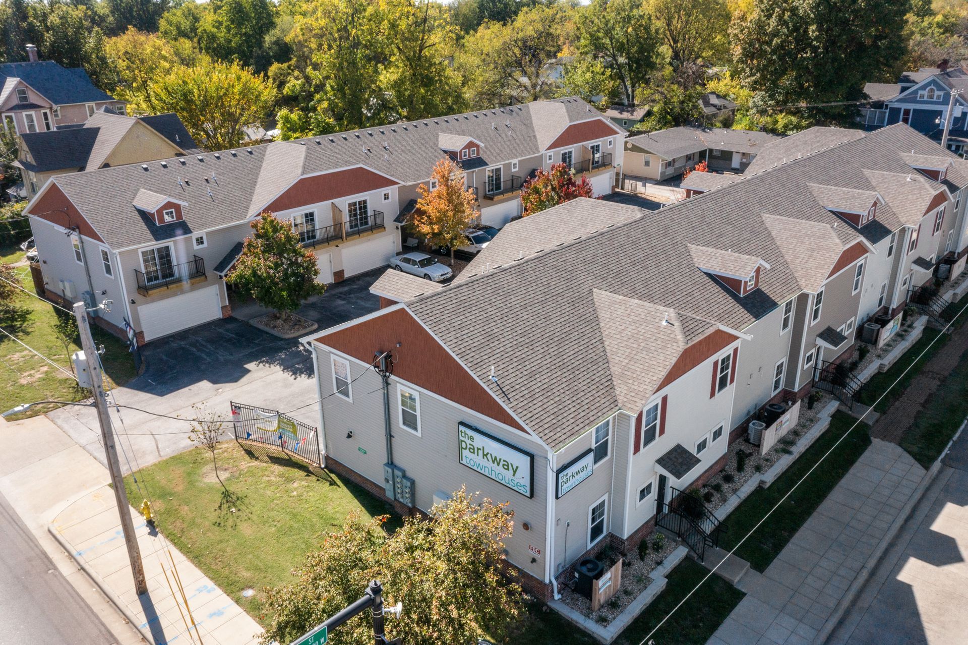 An aerial view of a row of apartment buildings in a residential area.