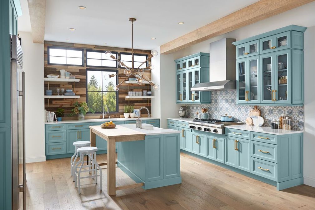 a kitchen with blue cabinets and a stove top oven