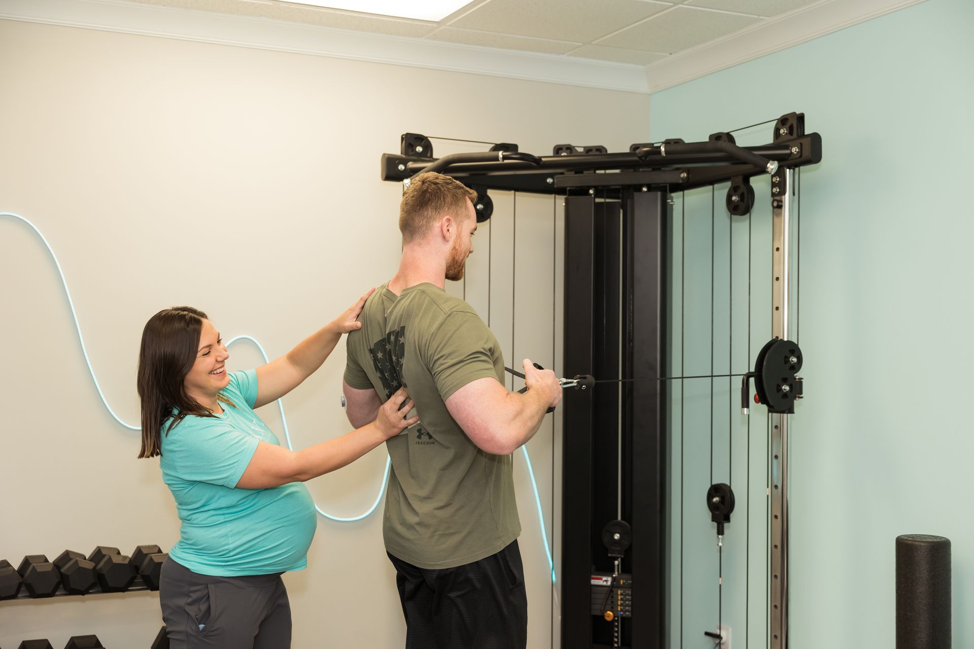 Physical Therapist helping patient with neck and back pain with exercise.