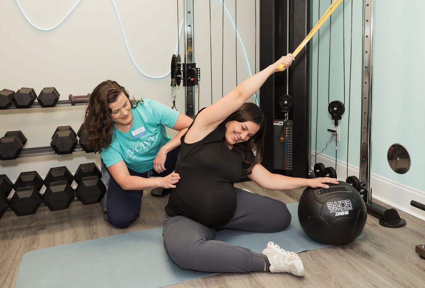 Physical therapist helping patient with birth preparation