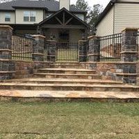 There are stairs leading up to the front of a house.