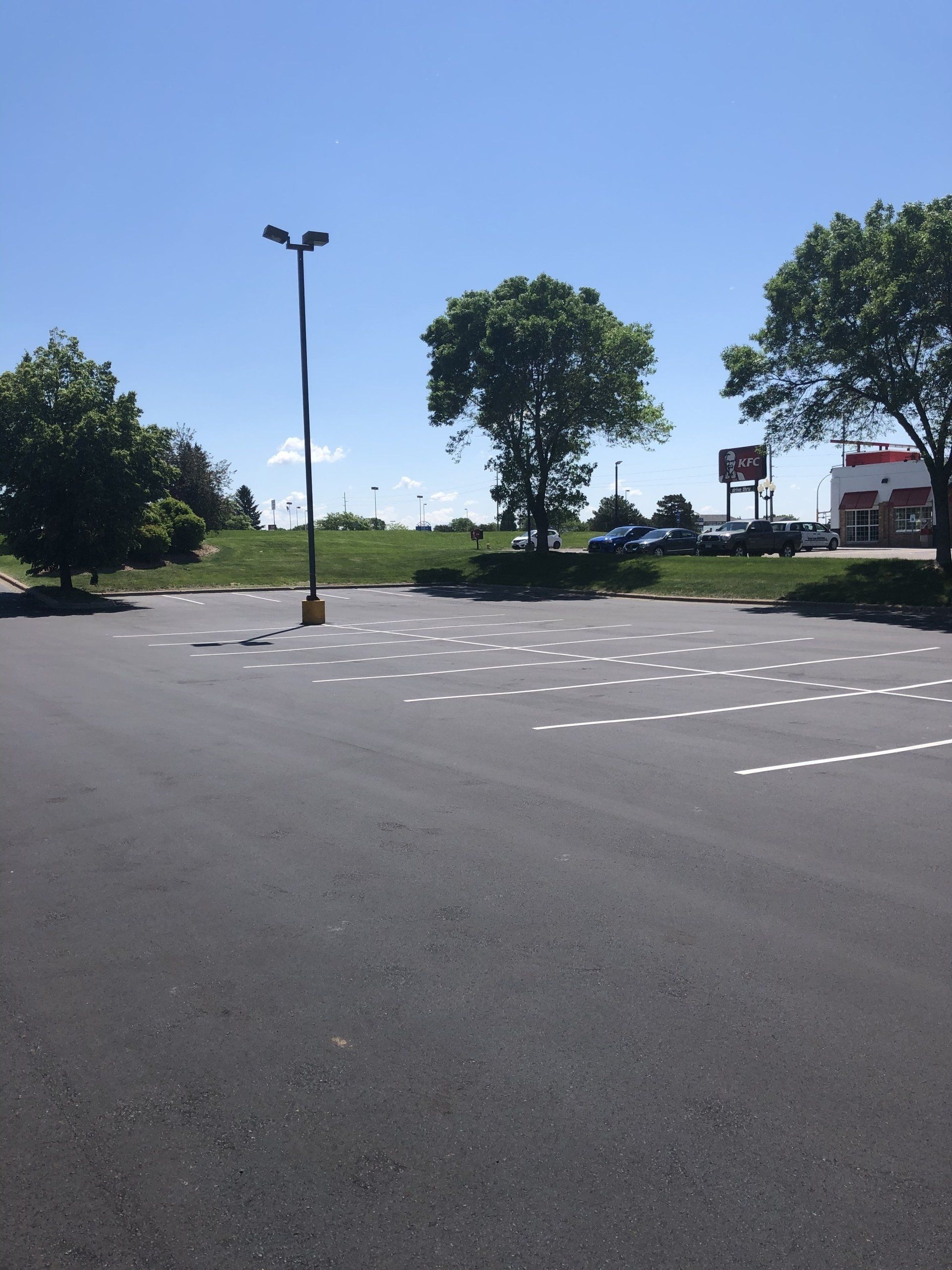 A parking lot with a coca cola sign in the background