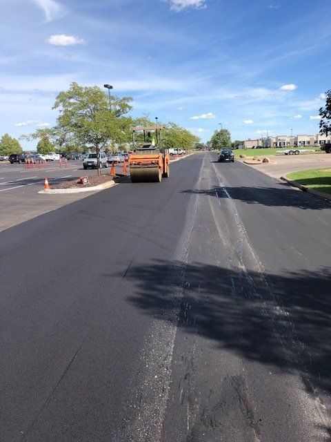 A road is being paved in a parking lot