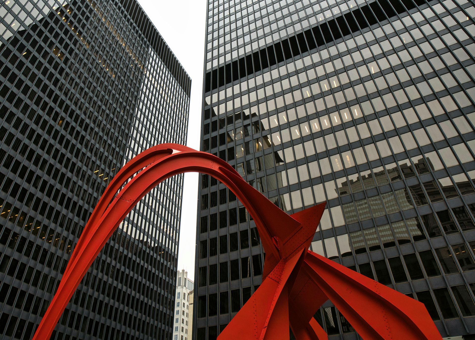 Milwaukee skyline with skyscrapers, lake, and white art museum under blue sky.