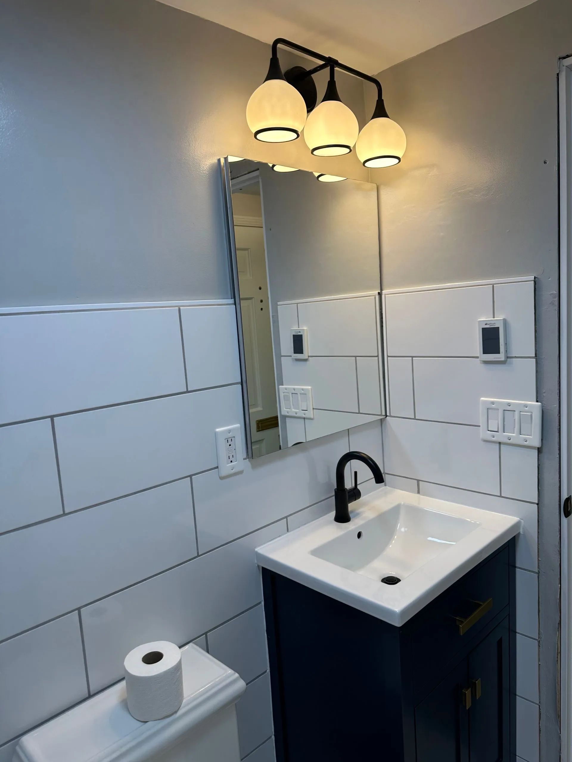 A bathroom with a sink , toilet and mirror