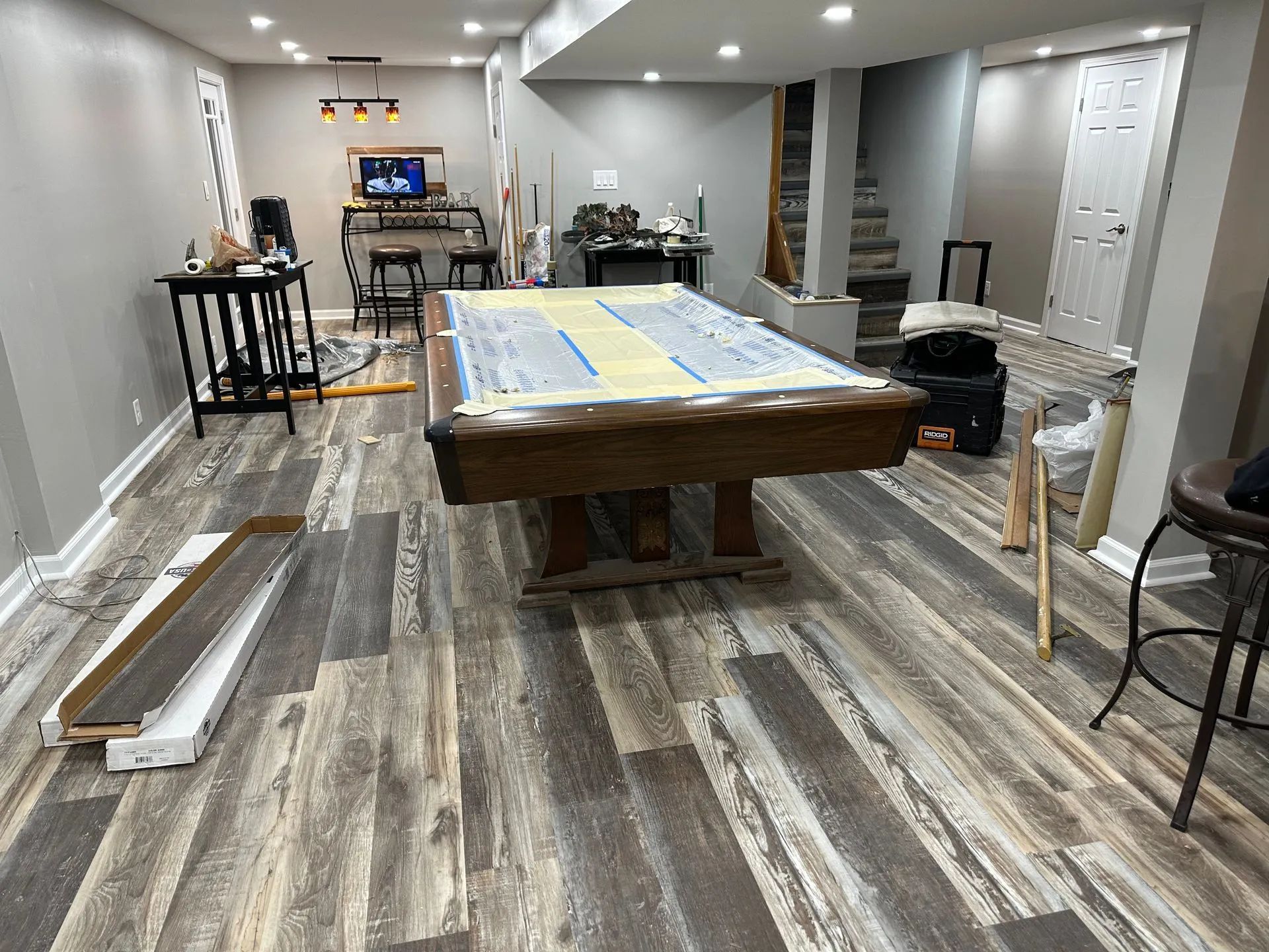 There is a pool table in the middle of the room.