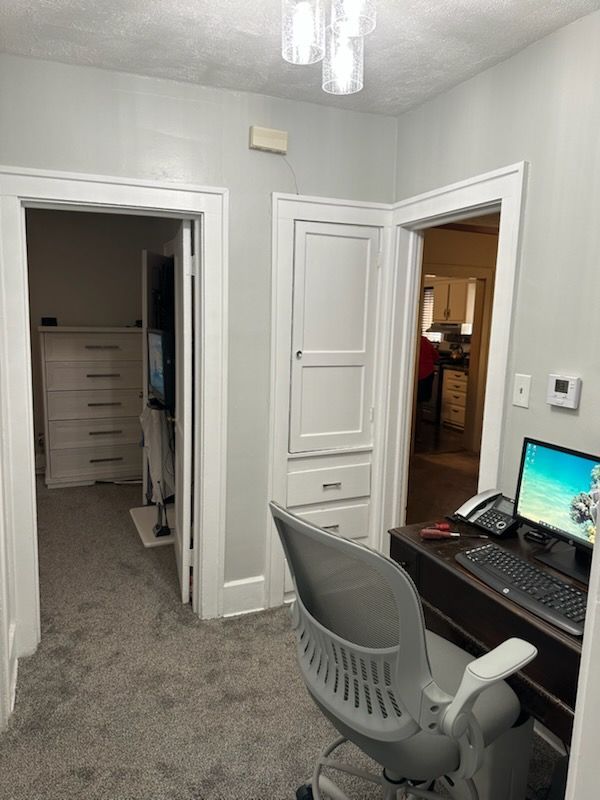 A hallway with stairs and a light on the ceiling