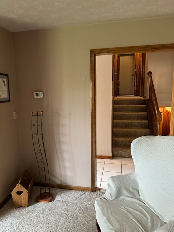 A bathroom with a toilet , sink and mirror.