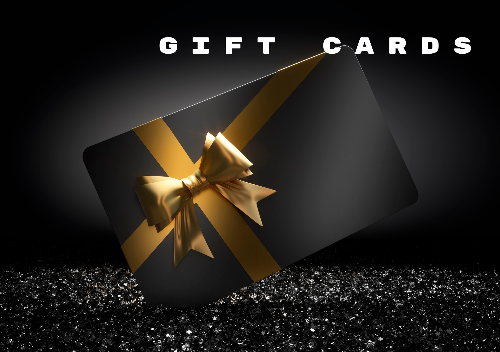 Black gift card with gold ribbon, on a bed of glitter, with 