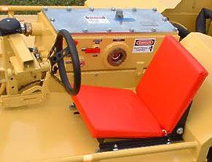 Yellow construction machine with red seat and black steering wheel.