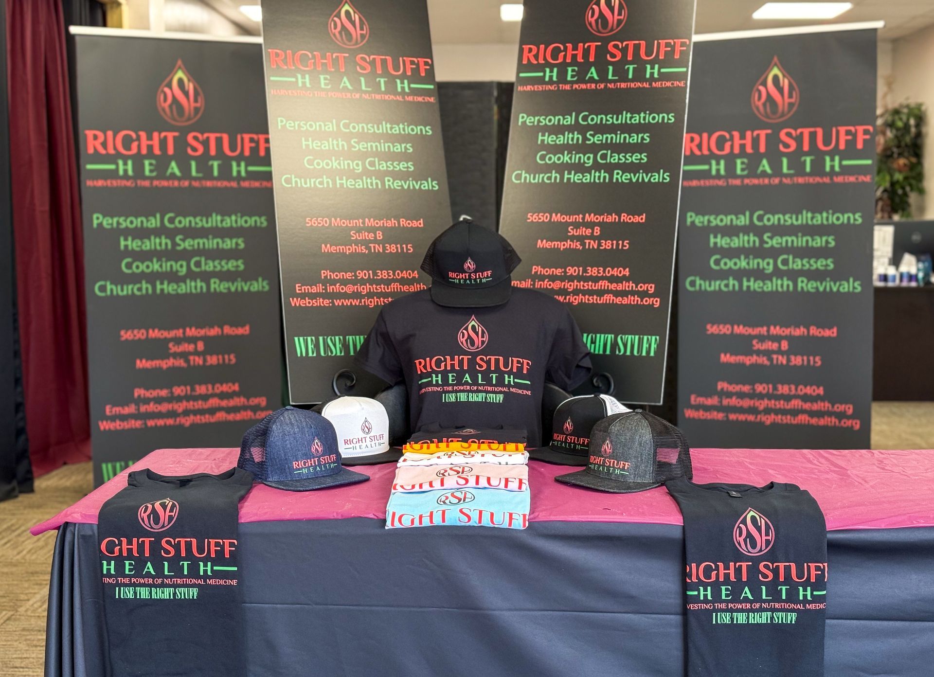 A table with shirts and hats on it for right stuff health