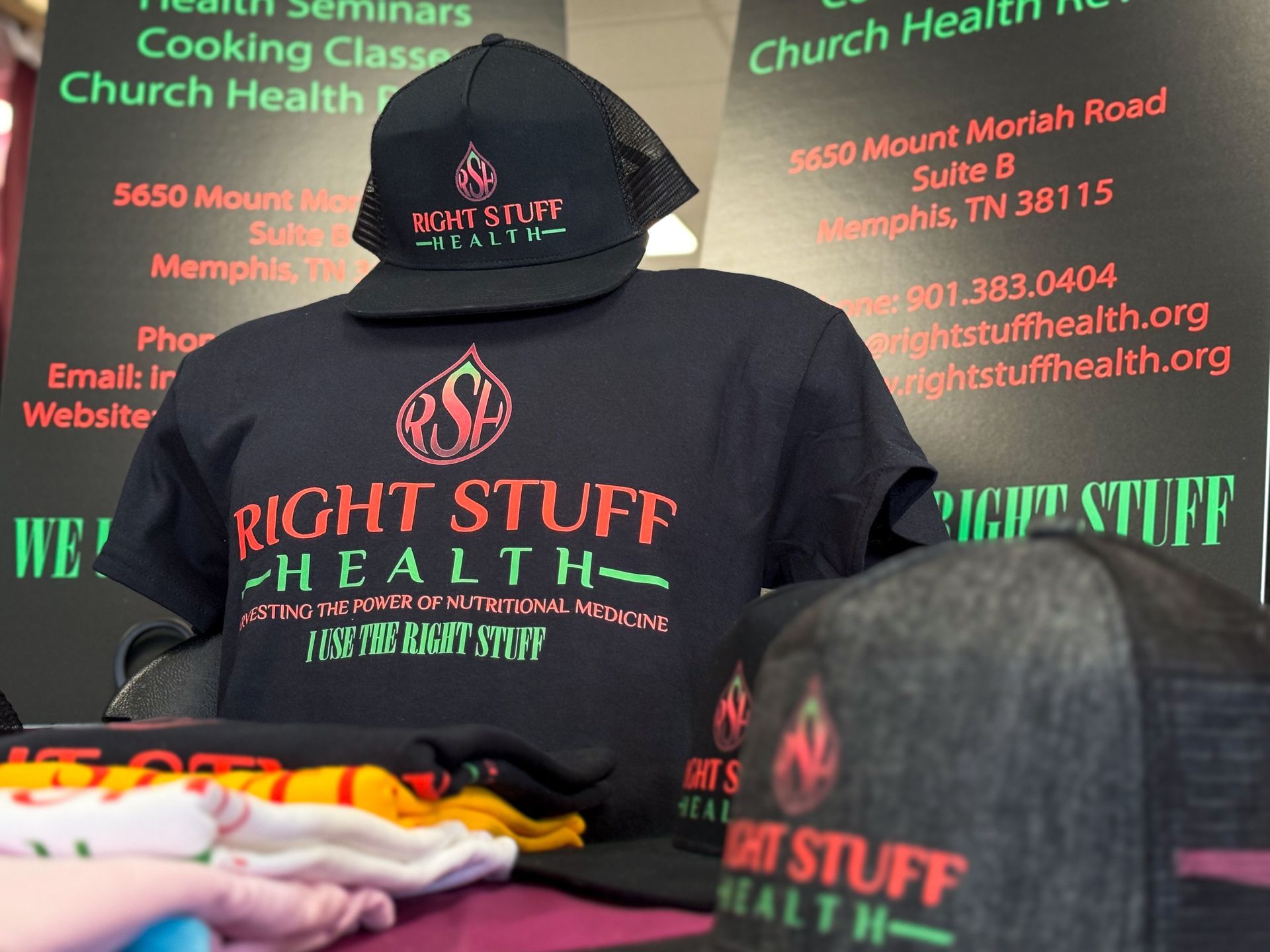 A stack of right stuff health shirts and hats