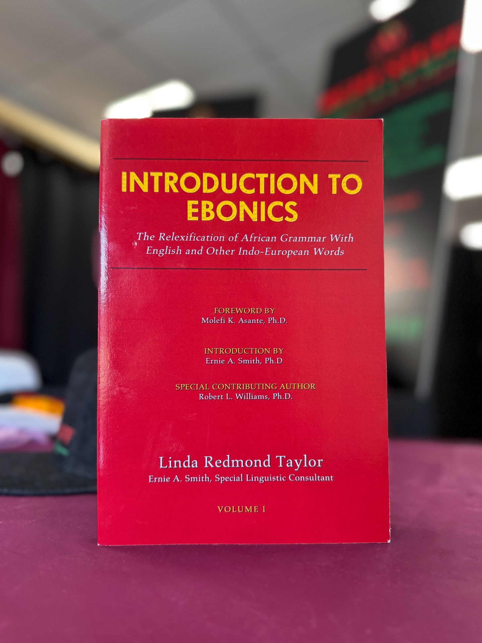 A red book titled introduction to eonics sits on a table