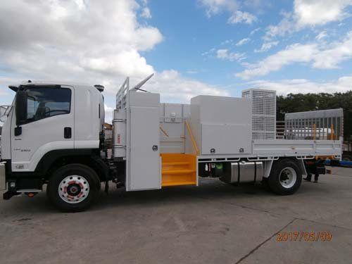 white workman truck with yellow steps