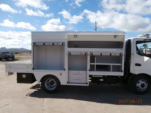 white workman truck with storage compartments