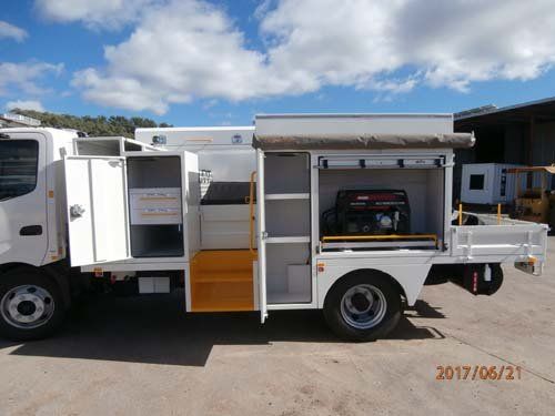 white workman truck with open storage compartments