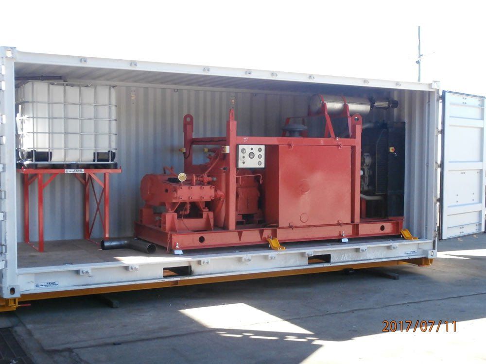 red machinery inside metal container