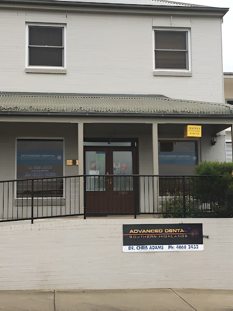 A White Building With a Sign That Says Advanced Dental — Advanced Dental Southern Highlands in Moss Vale, NSW