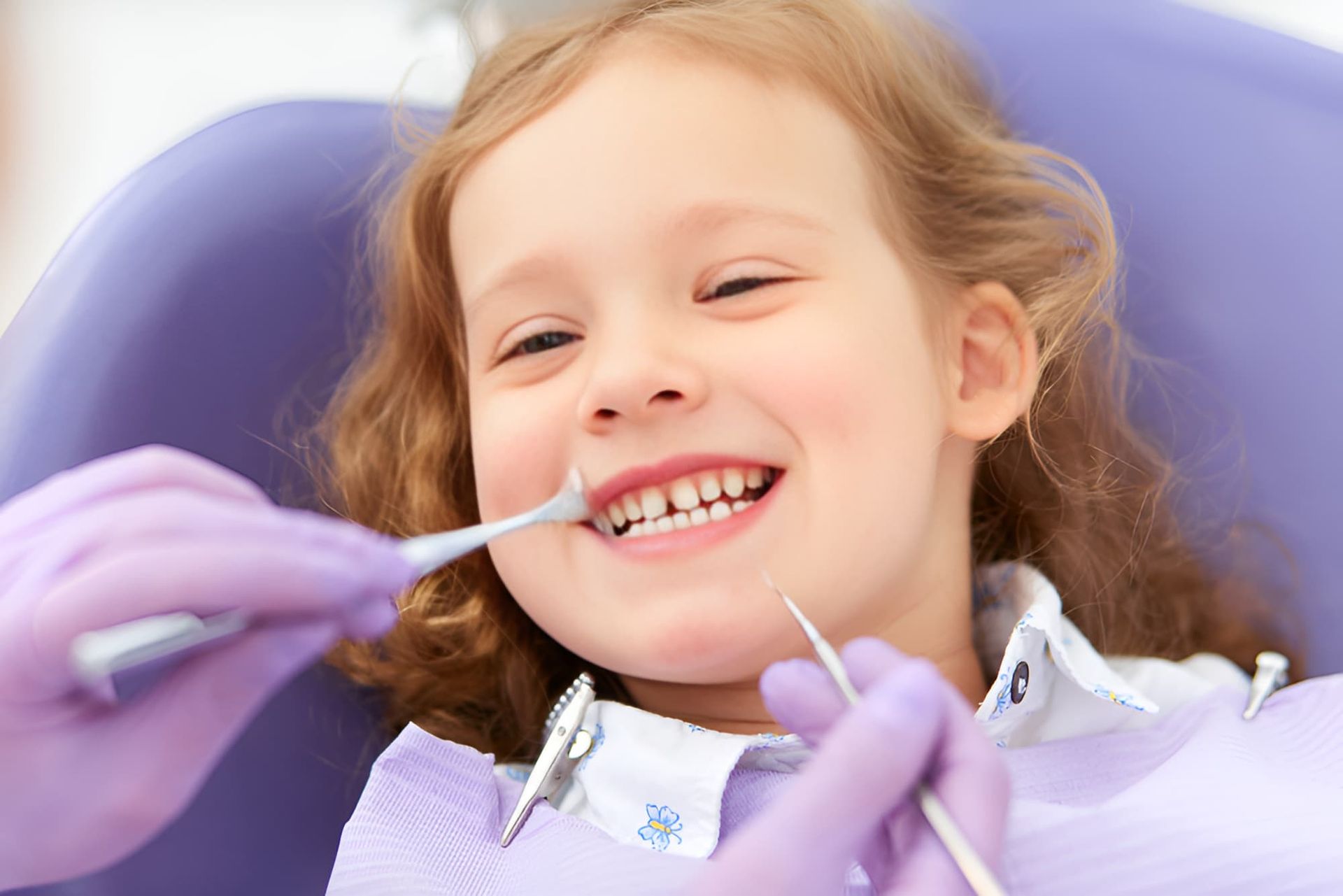 A Little Girl is Getting Her Teeth Examined by a Dentist — Advanced Dental Southern Highlands in Moss Vale, NSW