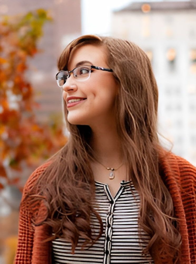 A Woman Wearing Glasses Smiling — Advanced Dental Southern Highlands in Moss Vale, NSW